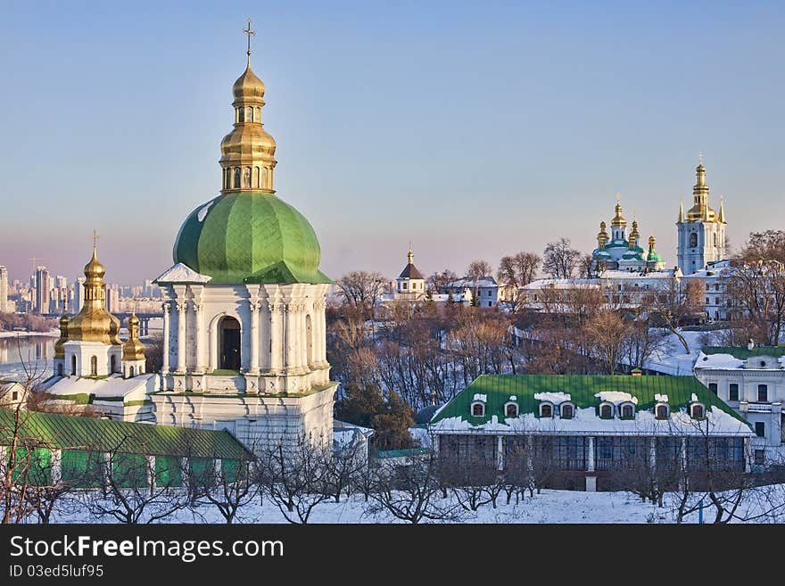 View of Kiev-Pechersk Lavra Monastery in snow at sunset