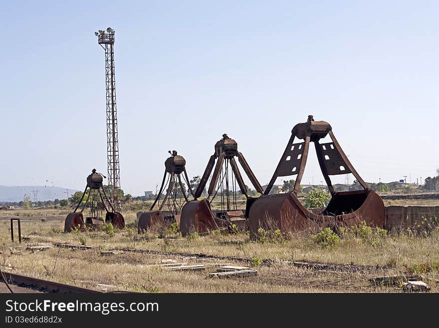 Tree old excavator shovel standing in line. Tree old excavator shovel standing in line