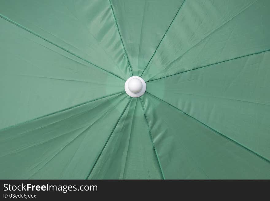 Green beach umbrella top background