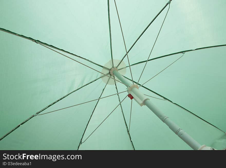 Green beach umbrella inside frame background