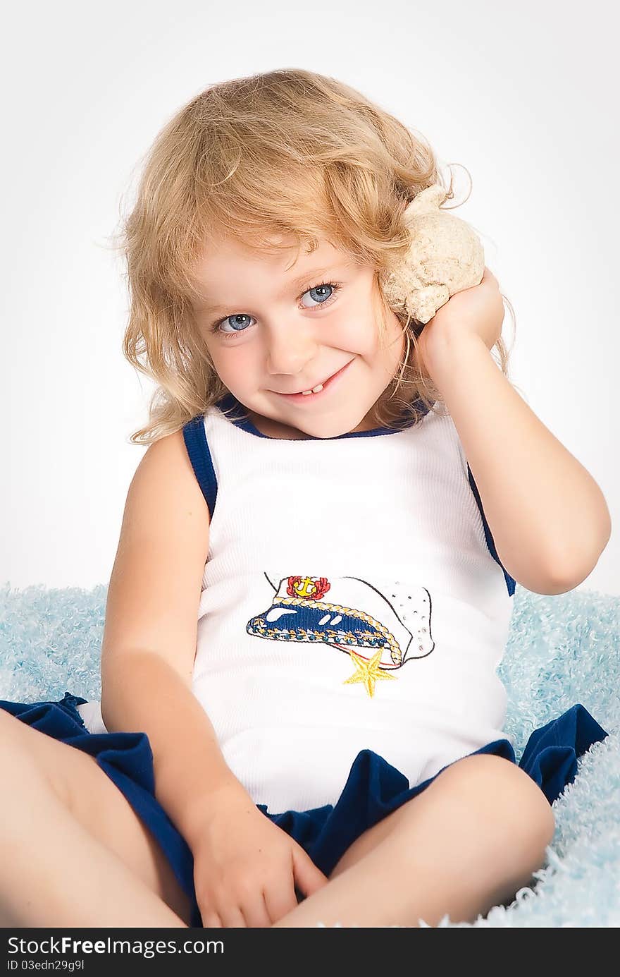 Isolated portrait of pretty girl with seashell in studio