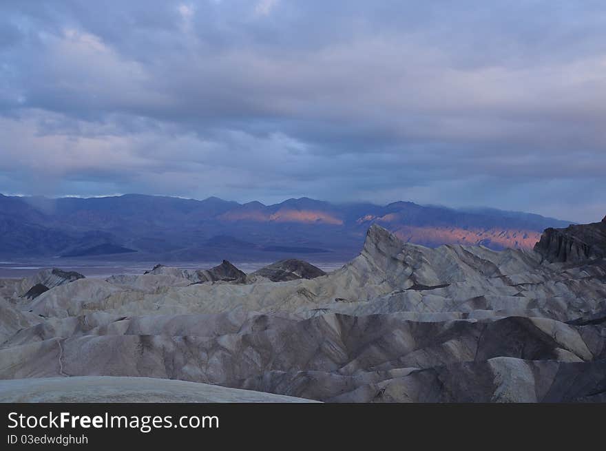 Breaking dawn over the mountains lighting up the valley in a single ribbon of light. Breaking dawn over the mountains lighting up the valley in a single ribbon of light