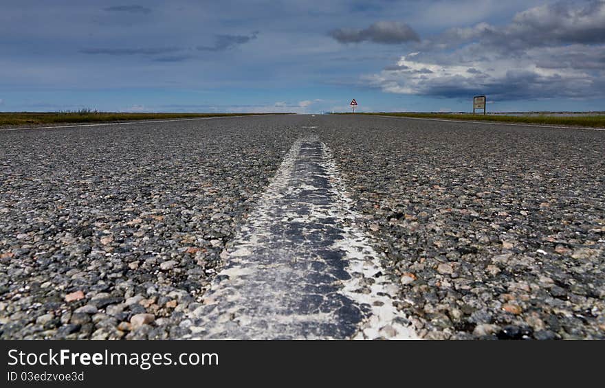 A street to horizon with a cloudy sky