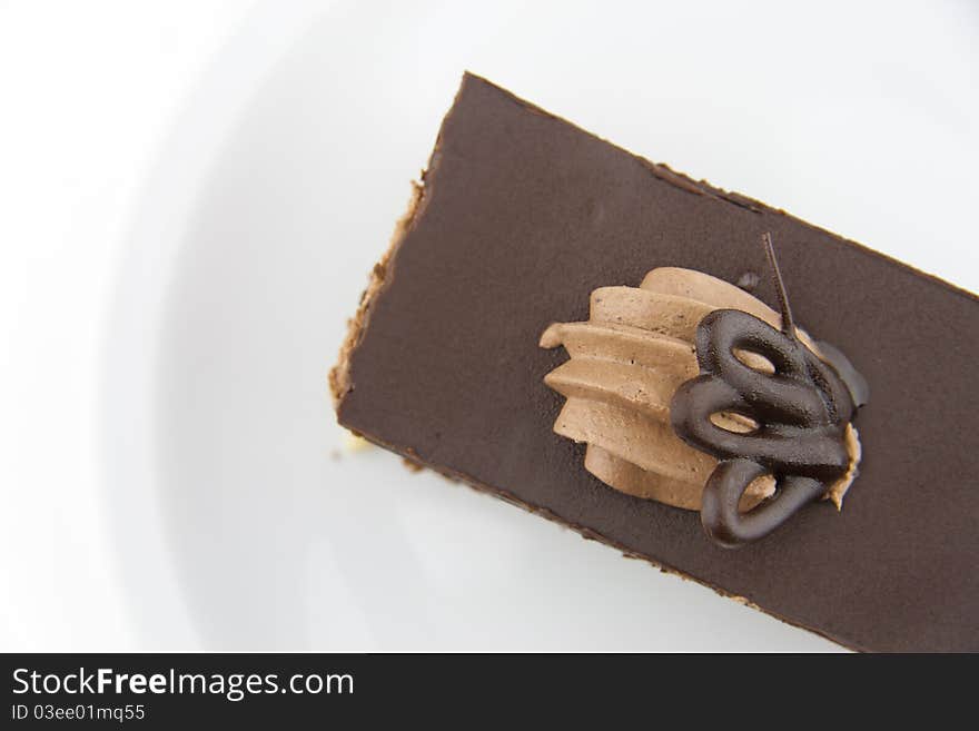 Chocolate cake on a white plate from above. Chocolate cake on a white plate from above