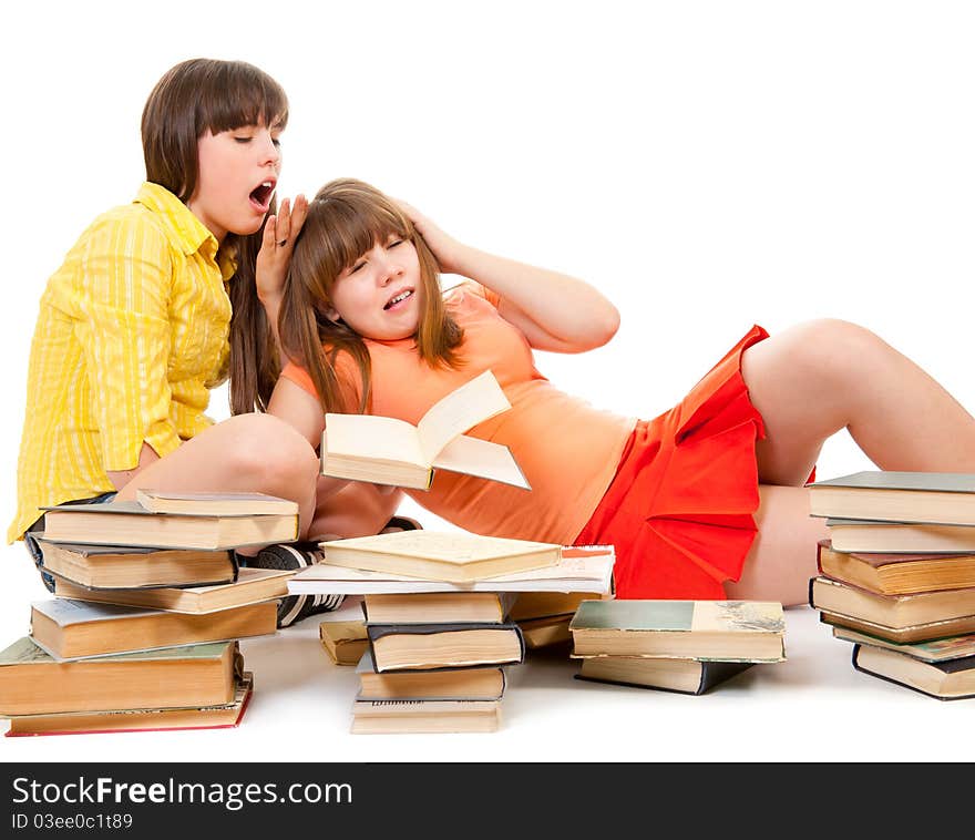 Two schoolgirls were tired of reading books and want to sleep