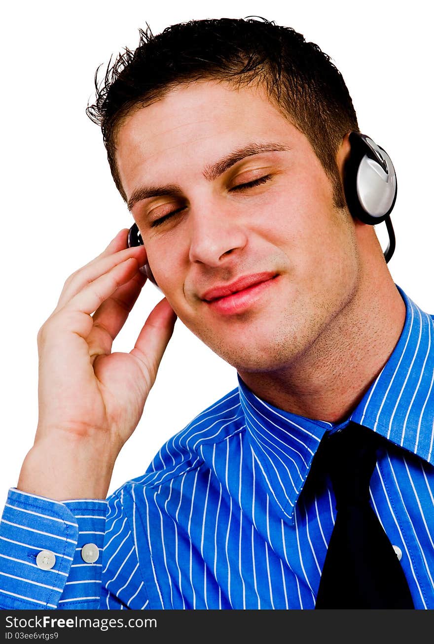 Man listening to music on a headphones and smiling isolated over white. Man listening to music on a headphones and smiling isolated over white