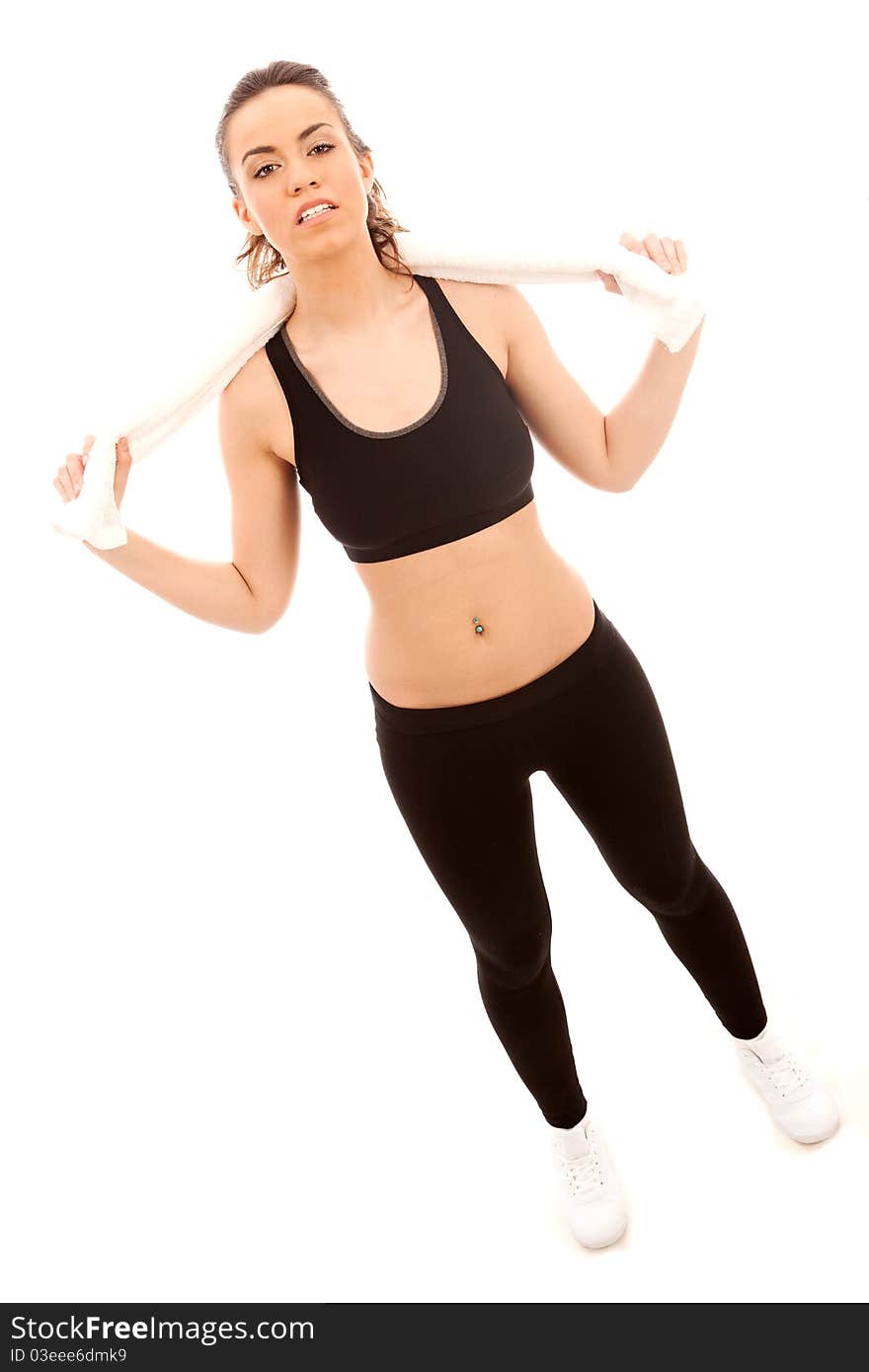 A young female dressed in black gym top holding a white twoel around her neck. A young female dressed in black gym top holding a white twoel around her neck