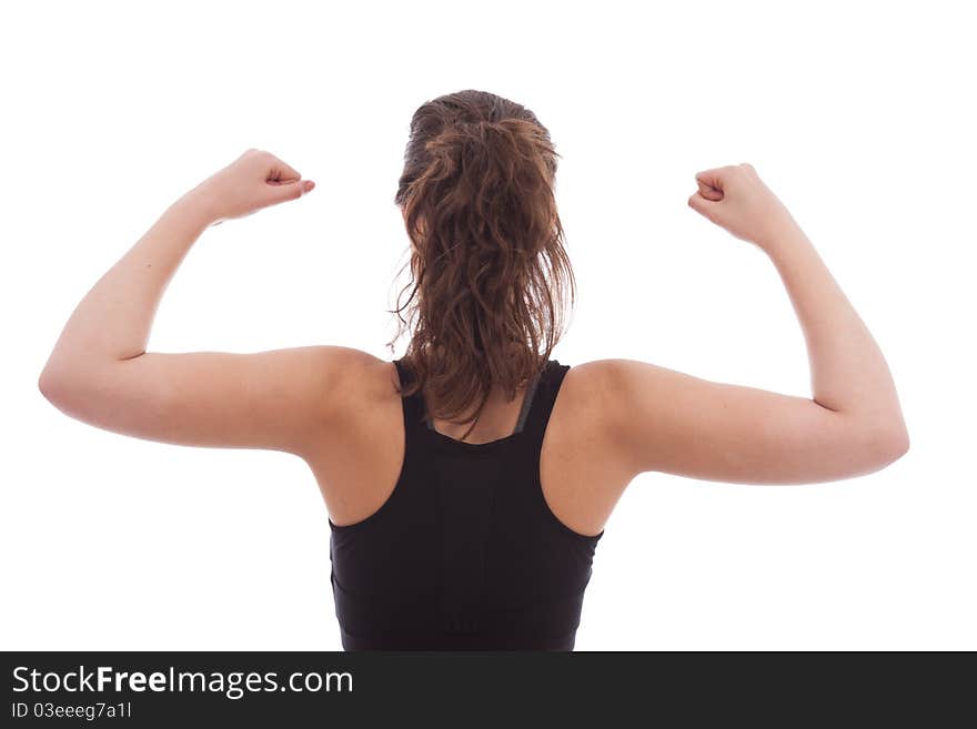 A young female dressed in black gym top facing away from camera. A young female dressed in black gym top facing away from camera