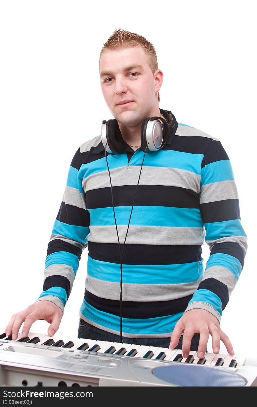 Boy plays piano, isolated in white background