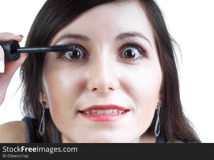 Beautiful girl with dark hair does a morning make-up