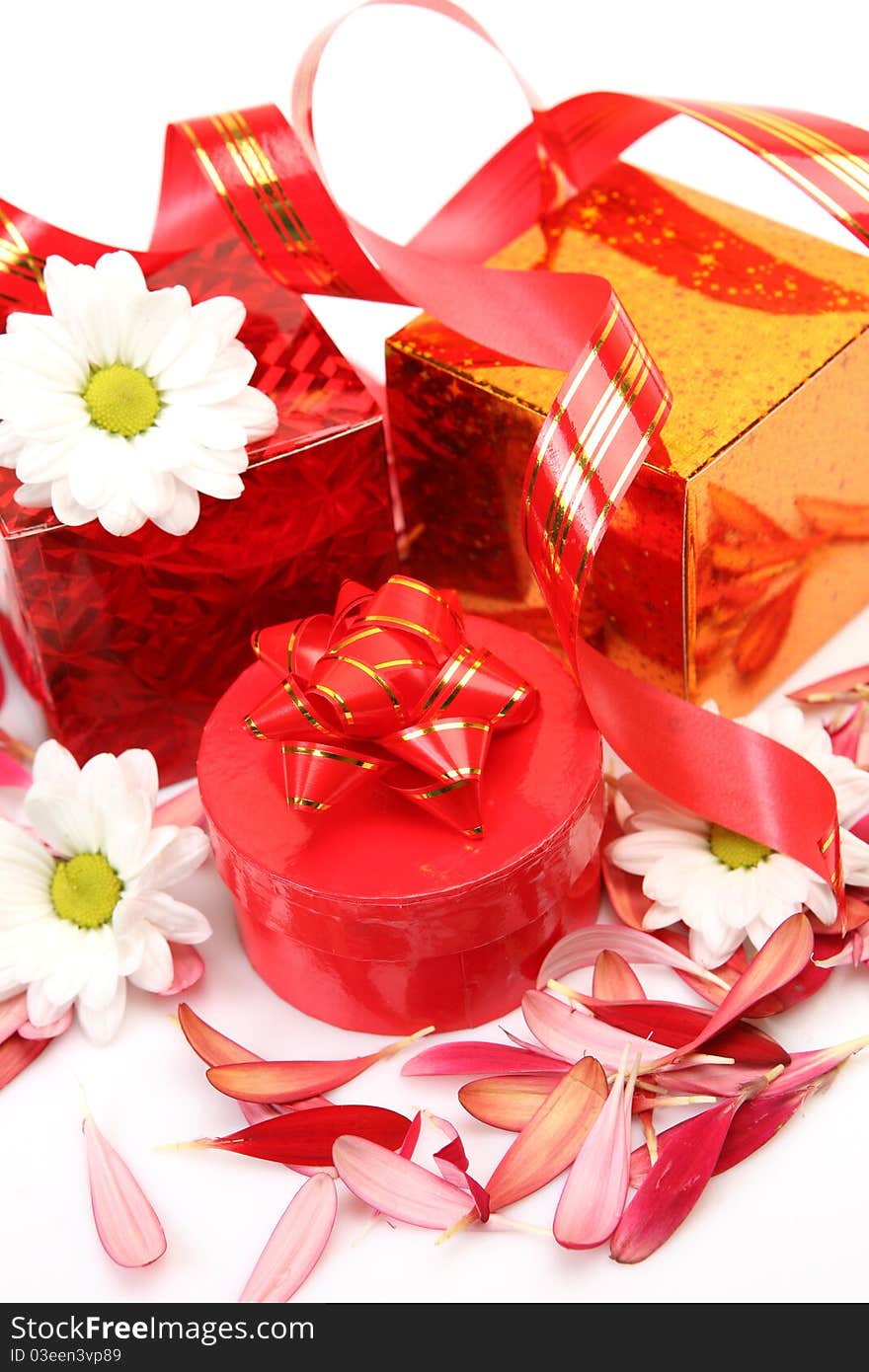 Boxes with gifts and a streamer on a white background