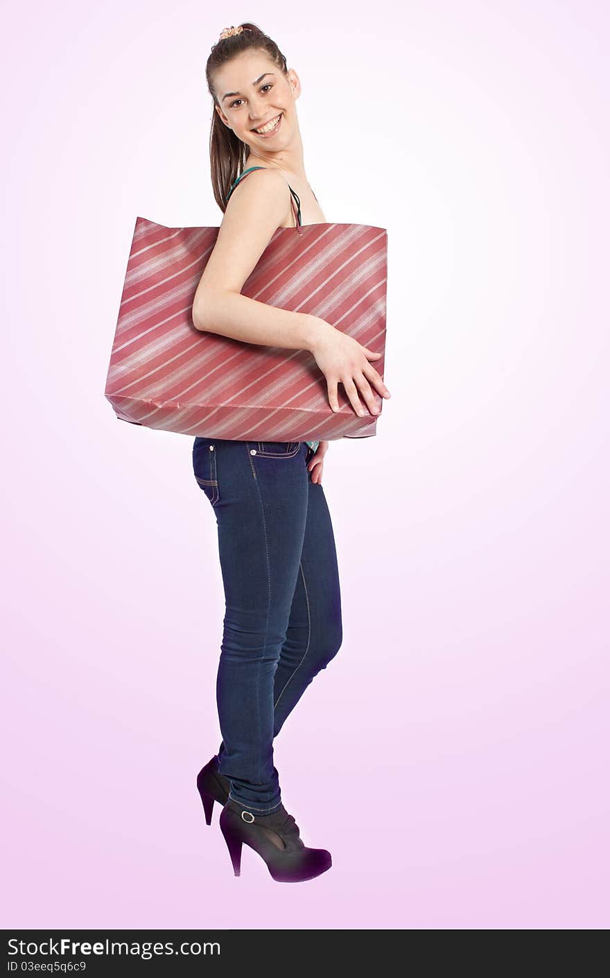 Beautiful girl with shopping bag over pink background. Beautiful girl with shopping bag over pink background