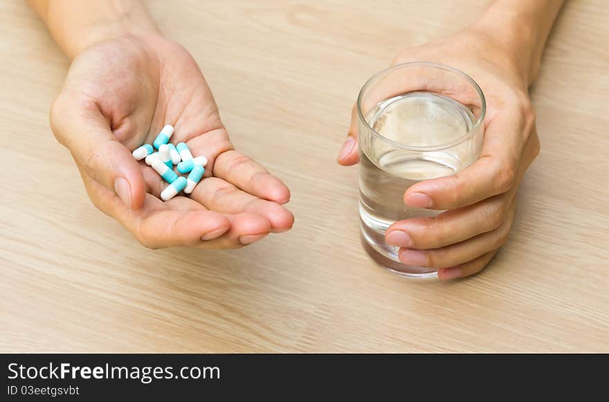 Tablet and a glass of water in hands. Tablet and a glass of water in hands