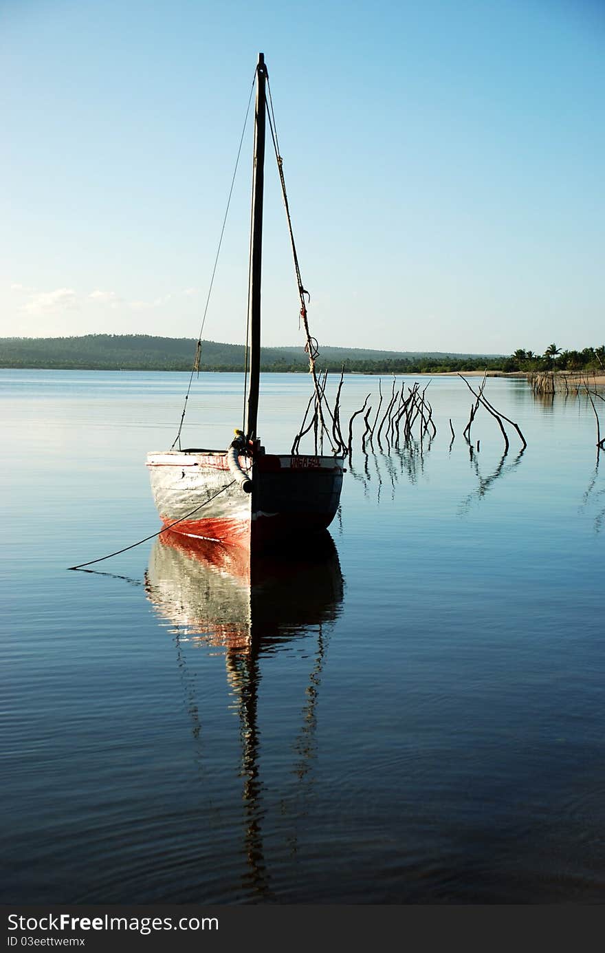 A fisherman's sail boat or dhow moored at a lagoon in Mozambique. A fisherman's sail boat or dhow moored at a lagoon in Mozambique