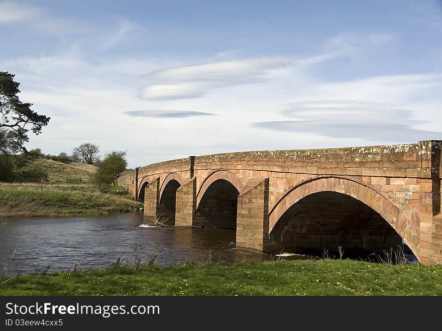 Red sandstone arched bridge across the river Eden,Cumbria,England,historic design. Red sandstone arched bridge across the river Eden,Cumbria,England,historic design.