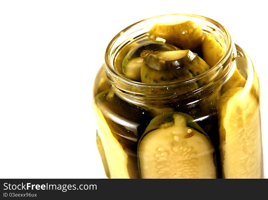 Close-up of a jar of pickles on a white background