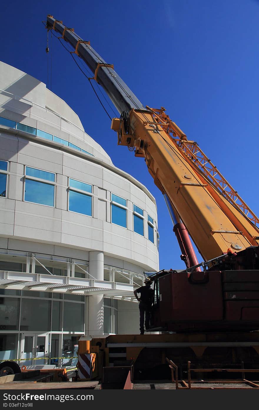 Big yellow crane reaching up toward the sky