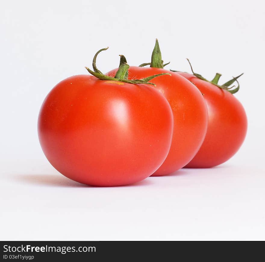 Three fresh tomatoes isolated on white background. Three fresh tomatoes isolated on white background