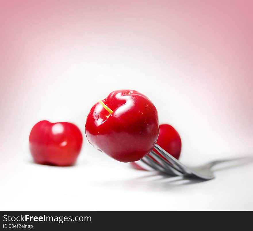 Macro image of cherry on fork