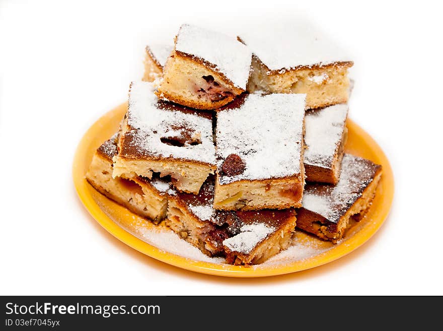 Berry and nut pie on a yellow plate