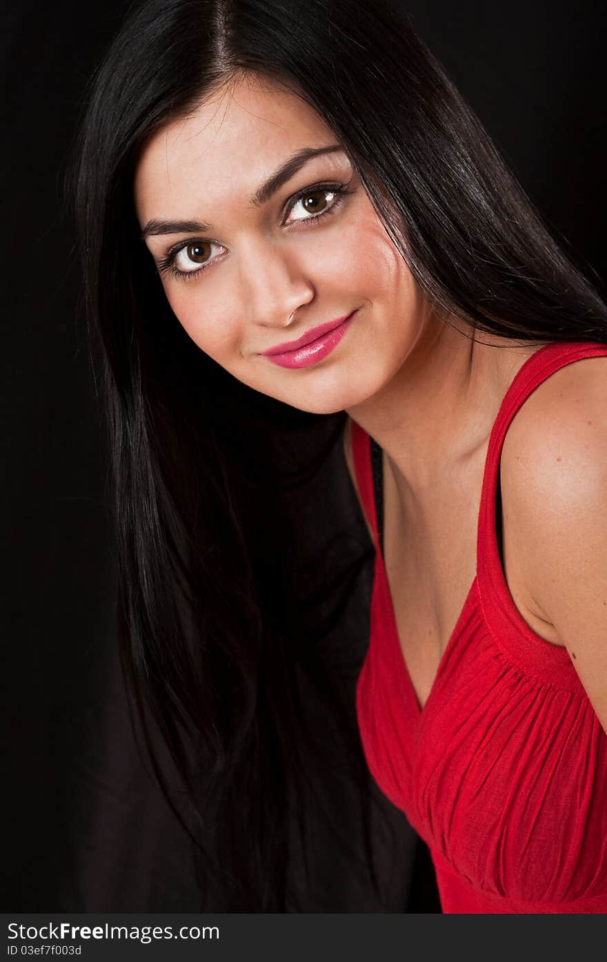 Portrait of young pretty woman in red dress