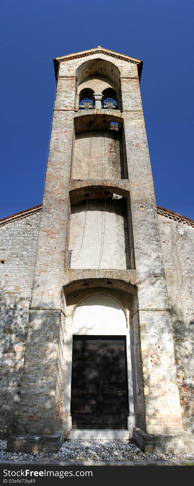 Ancient bell tower called sailing of the church of the fourteenth century. In Udine, Italy.