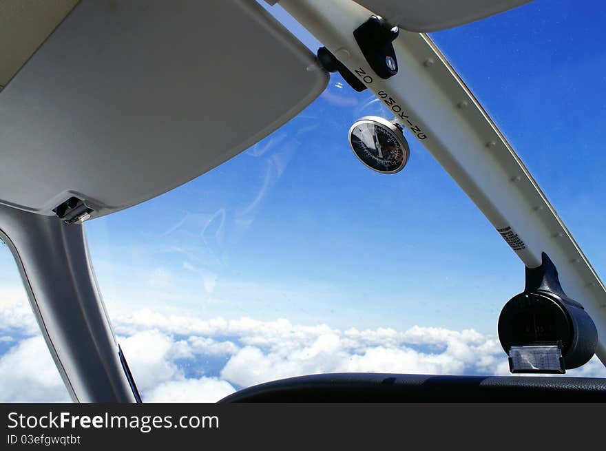 A shot of clouds and blue sky taken from a cockpit of a light aircraft at 5000 feet. A shot of clouds and blue sky taken from a cockpit of a light aircraft at 5000 feet.