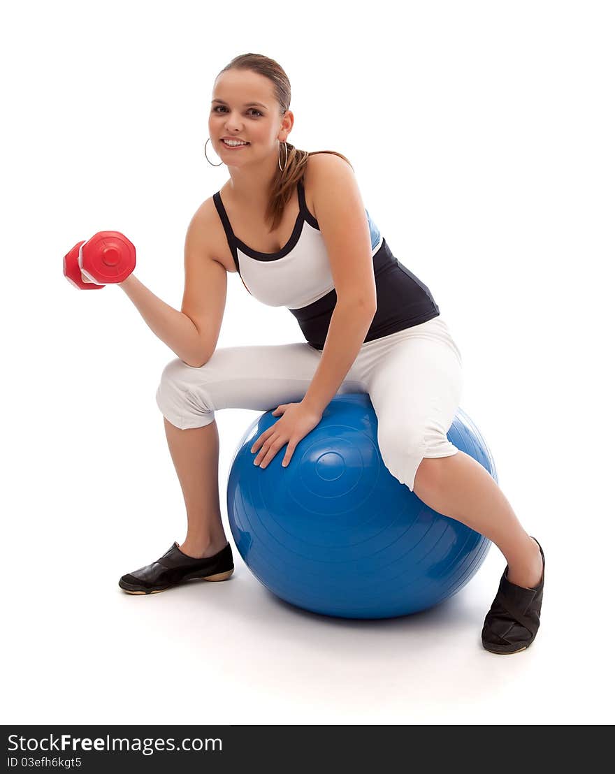 Lovely smiling woman is working out on a blue fitness ball. Lovely smiling woman is working out on a blue fitness ball