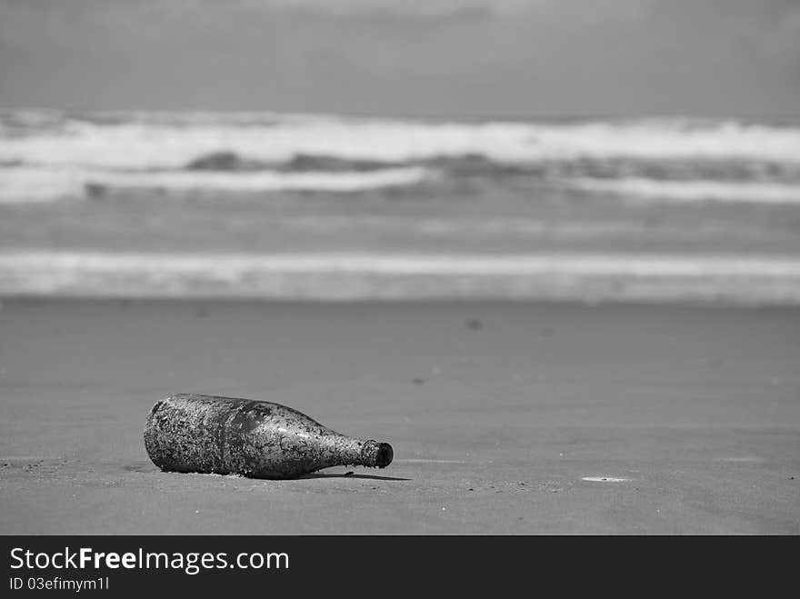 Empty bottle littered on the beach. Empty bottle littered on the beach