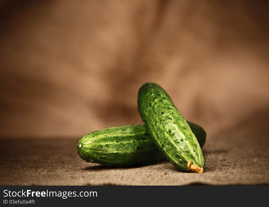 Fresh cucumbers on the sacking background. Fresh cucumbers on the sacking background