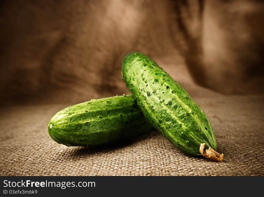 Fresh cucumbers on the sacking background