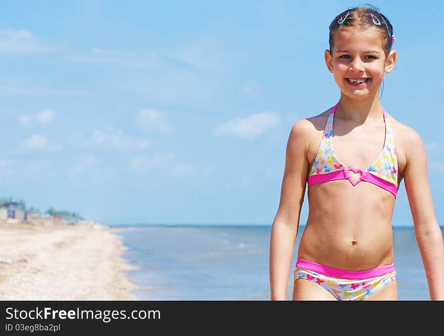 A happy child is running at the beach. A happy child is running at the beach.