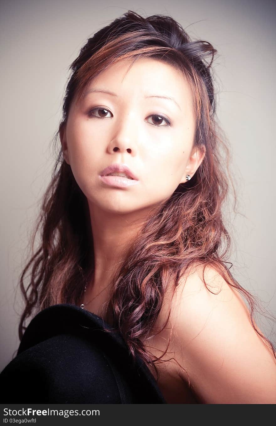 Asian young woman in black fashion shoot.