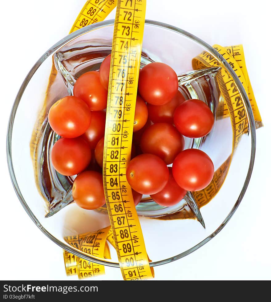 Tomatoes with measuring tape as losing weight concept isolated. Tomatoes with measuring tape as losing weight concept isolated