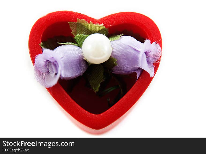 Heart in which artificial flowers isolated on white background