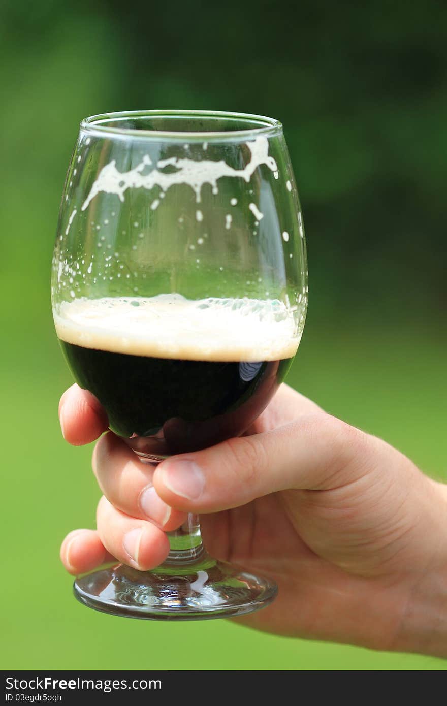 Man with one  beer glass with dark beer. Man with one  beer glass with dark beer