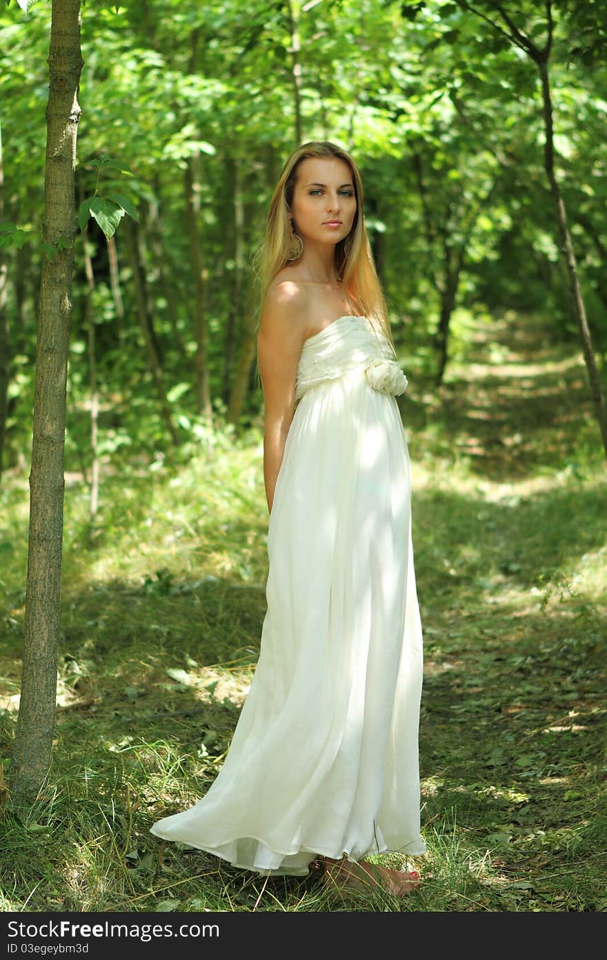 Blond girl in summer forest