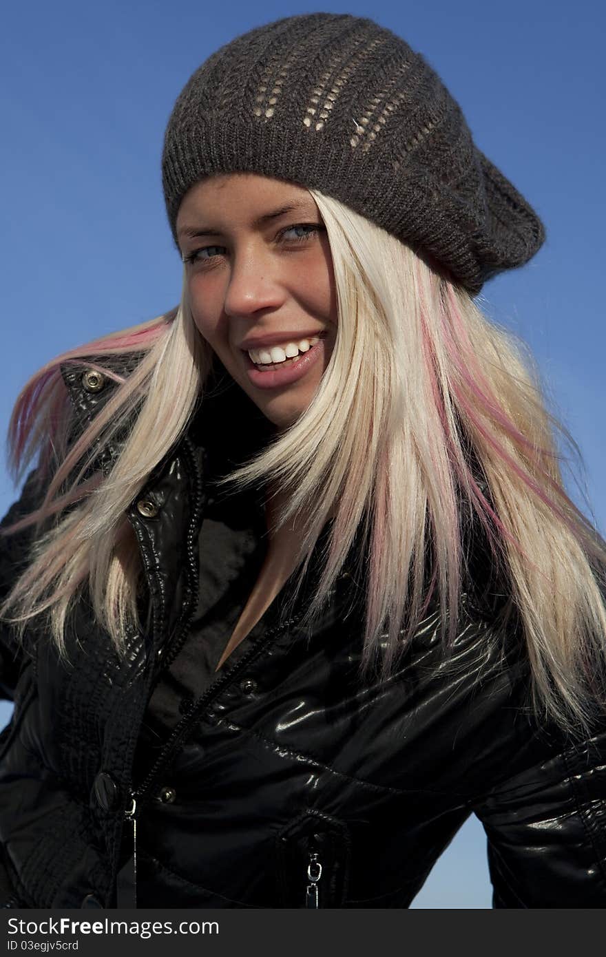 Beautiful young woman under blue sky. Portrait