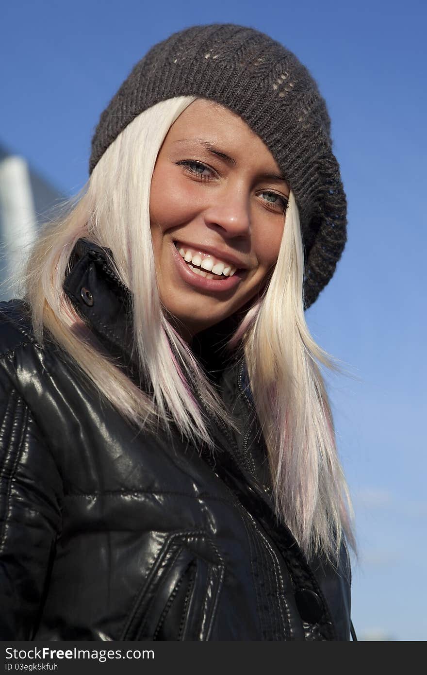 Beautiful young woman under blue sky. Portrait