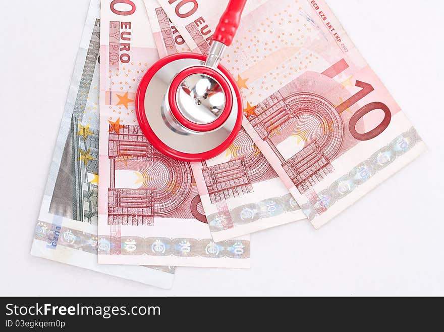 Red stethoscope is over euro money background. Red stethoscope is over euro money background.