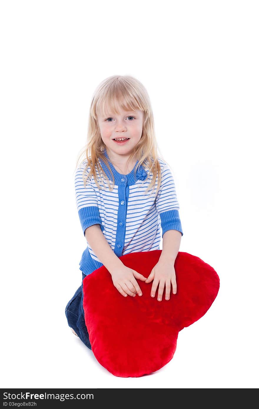 Cute child with red heart looking at camera