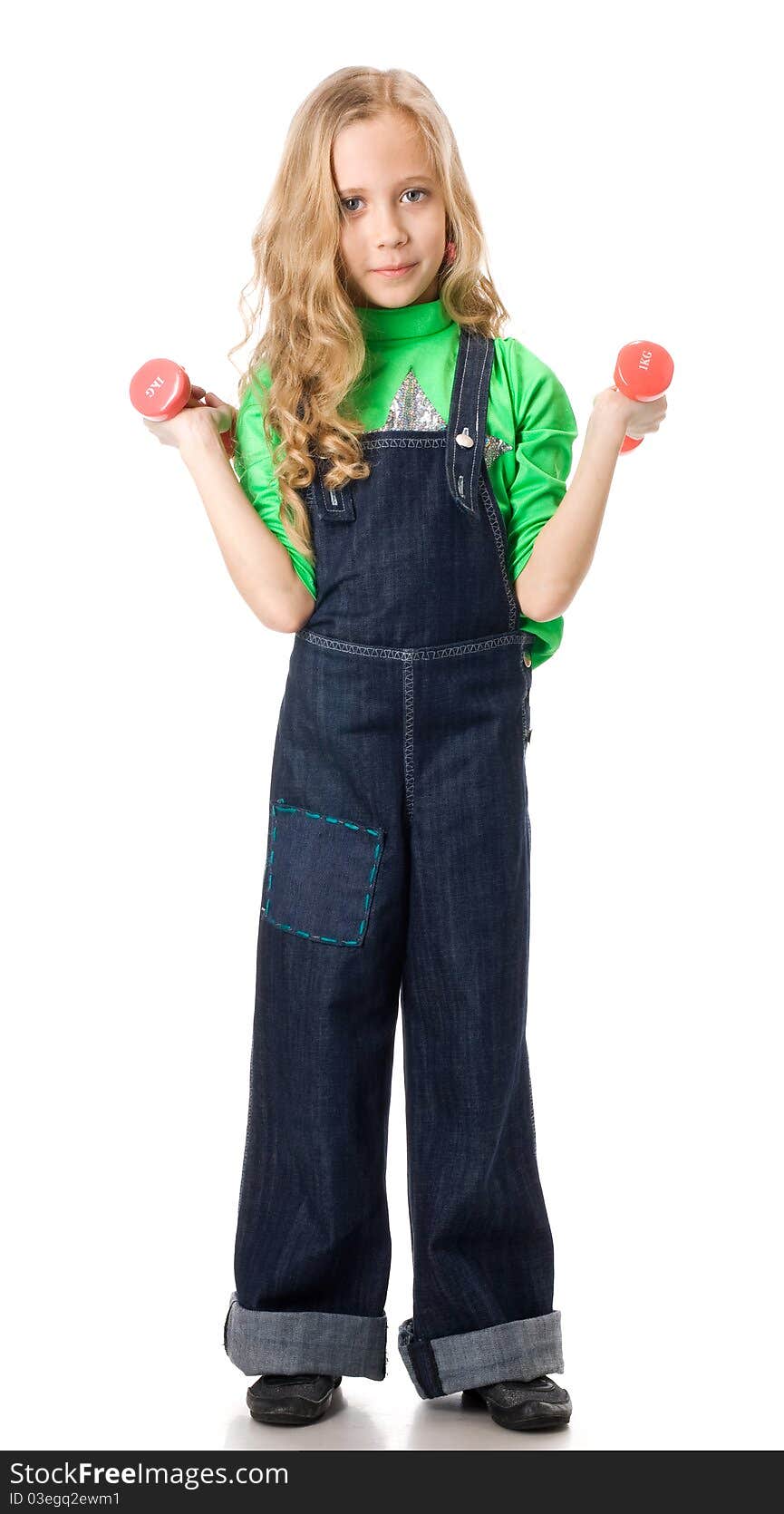 Young girl exercising with two pink dumbells. Young girl exercising with two pink dumbells.