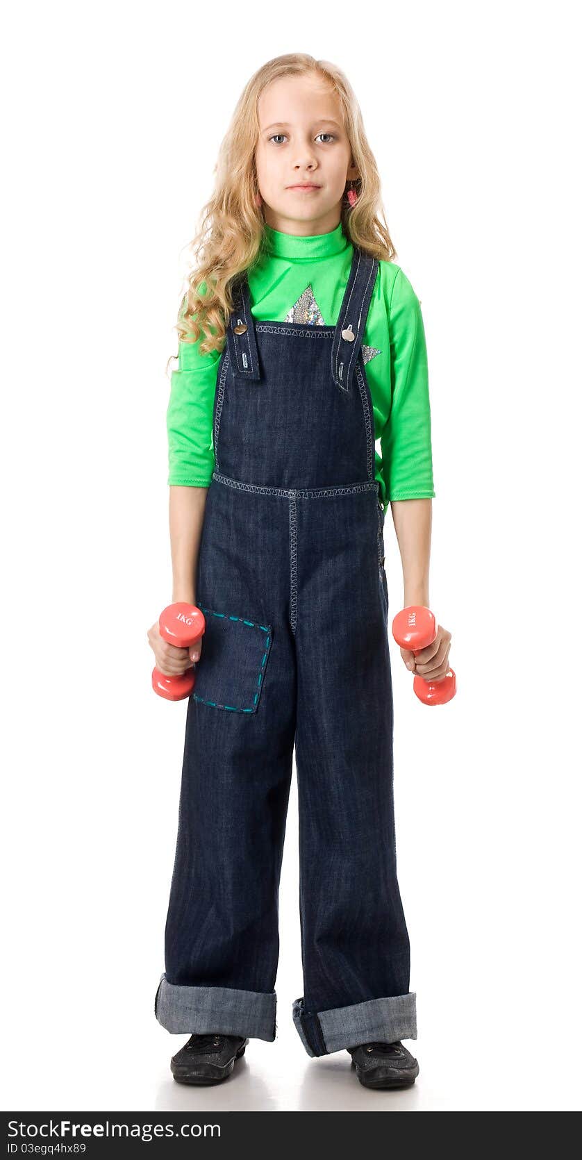 Young girl exercising with two pink dumbells. Young girl exercising with two pink dumbells.