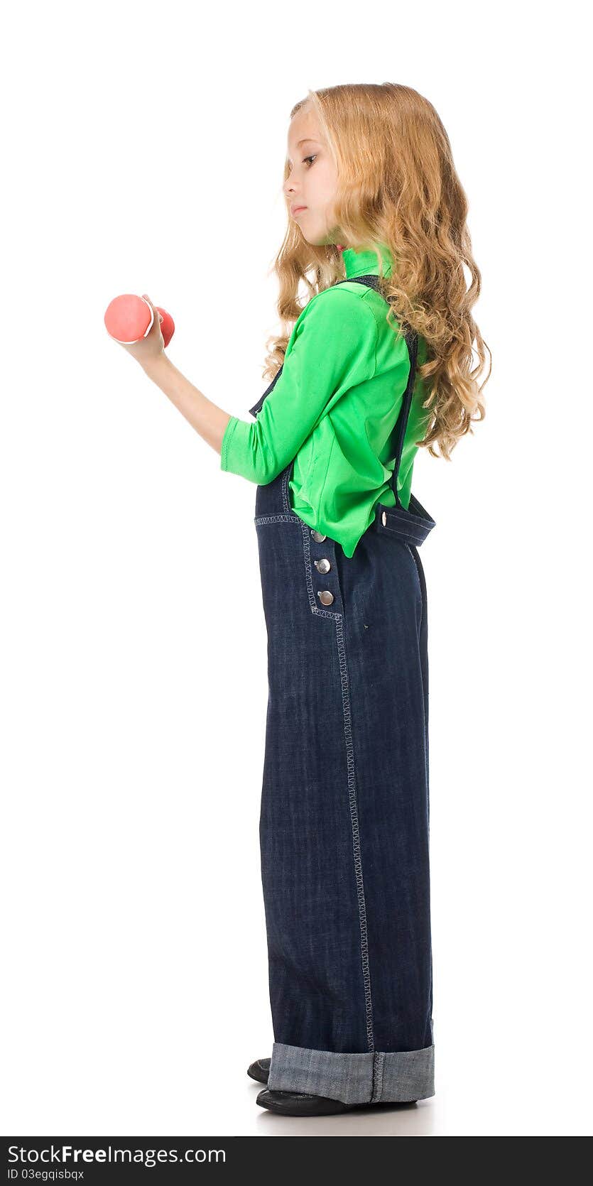 Young girl exercising with two pink dumbells. Young girl exercising with two pink dumbells.