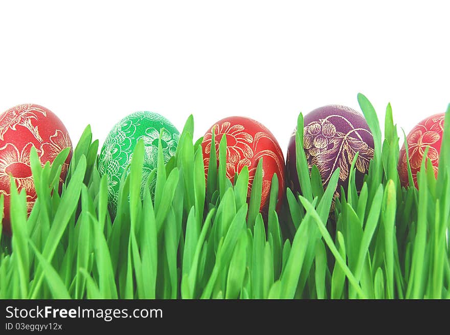 Traditional scratched hand-made Easter eggs on a grass