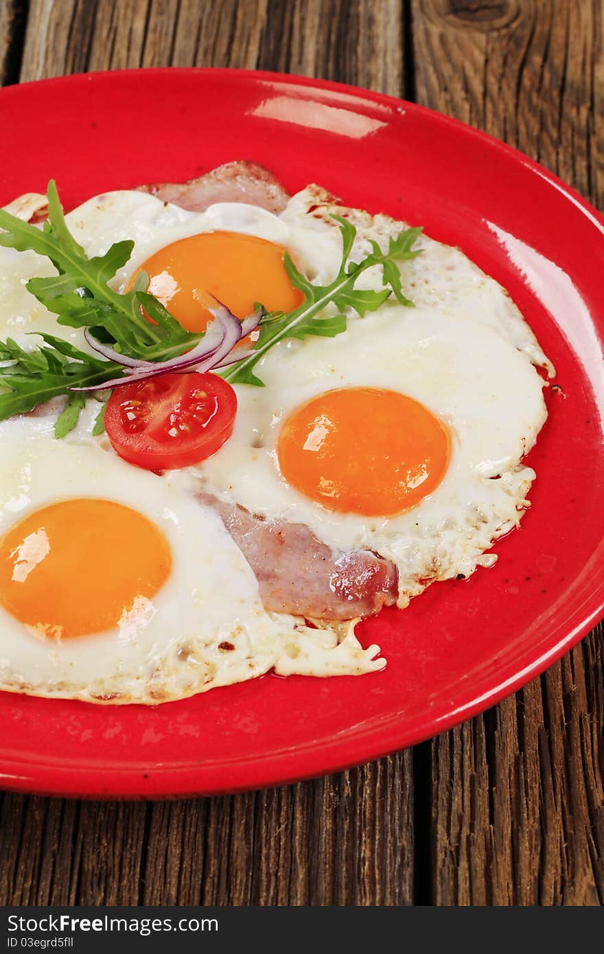 Fried eggs with slices of bacon - sunny side up. Fried eggs with slices of bacon - sunny side up