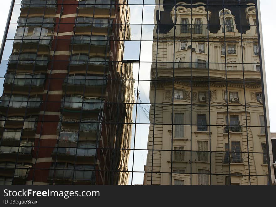 A street in Buenos Aires. Reflection of two tall buildings. A street in Buenos Aires. Reflection of two tall buildings.