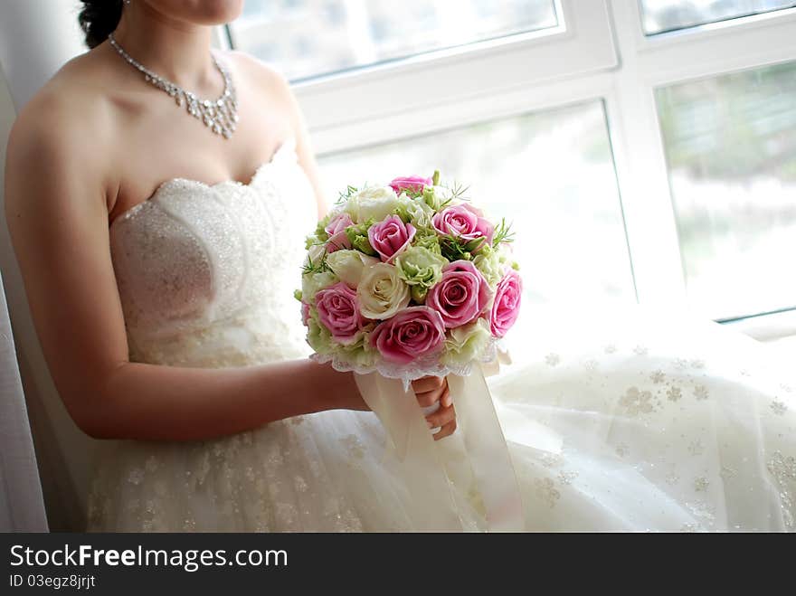 A beautiful bride at wedding. She is Holding flowers. A beautiful bride at wedding. She is Holding flowers