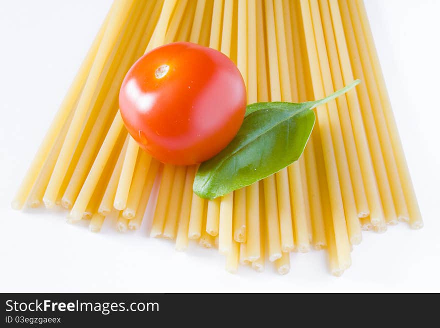 Italian raw pasta with tomato and basil. Italian raw pasta with tomato and basil