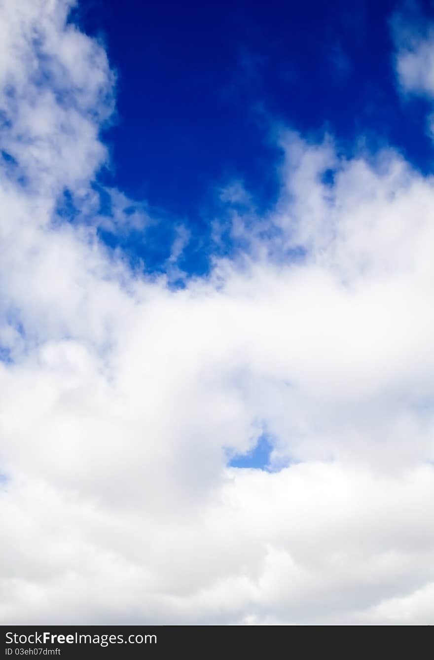 Dark blue sky behind dense clouds